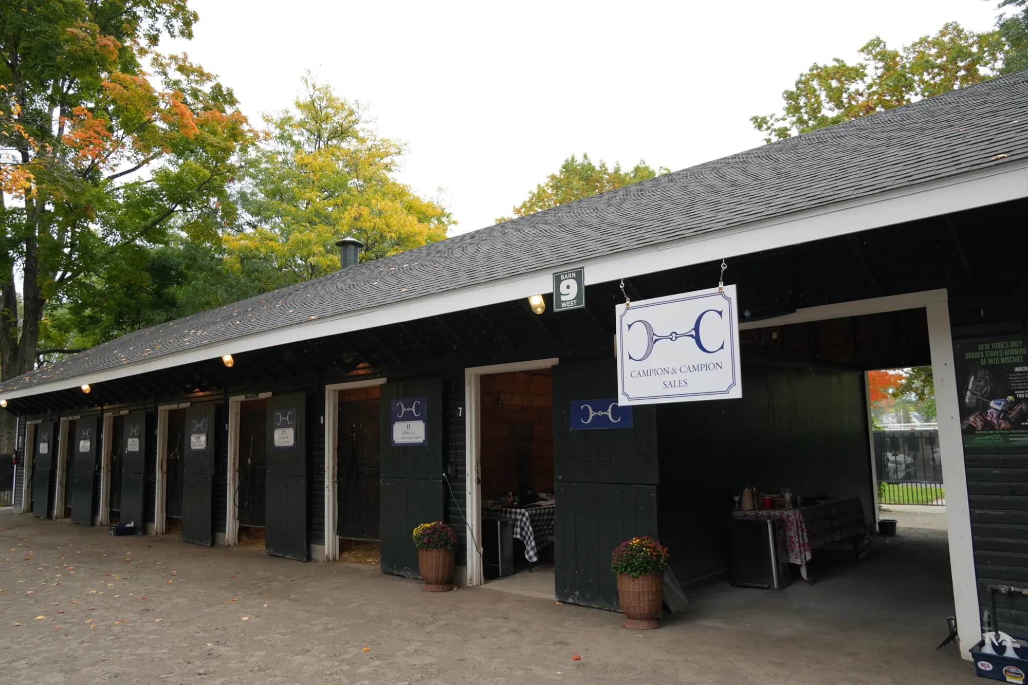 The Campion & Campion shedrow and hanging sign at Saratoga in autumn
